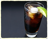 A glass of cola with ice and lemon